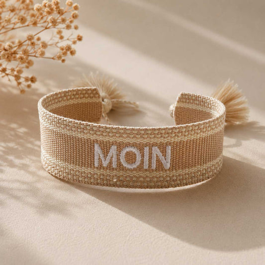 Beiges Statement Armband mit weißer MOIN Stickerei und cremefarbenen Quasten, Draufsicht mit Trockenblumen – Saltyblush
