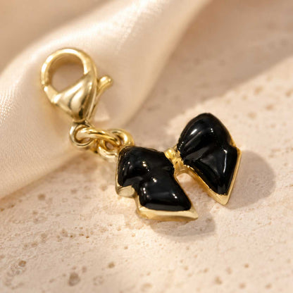 Schwarzer Schleife-Charm aus Edelstahl gold-schwarz von Saltyblush – Bow Charm, 1,5 x 1 cm
