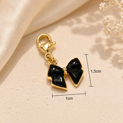 Schwarzer Schleife-Charm aus Edelstahl gold-schwarz von Saltyblush – Bow Charm, 1,5 x 1 cm
